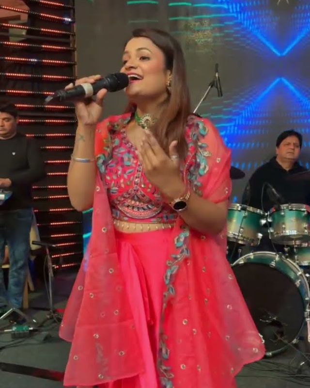 Paaridhi Sharma performing with drums and keys behind her