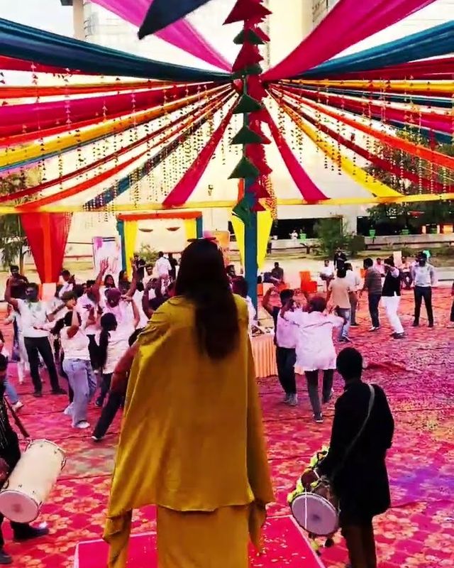 A Holi celebration under a colourful canopy