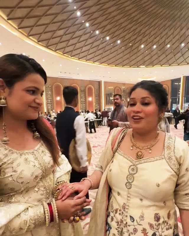 A host speaking to camera at a banquet hall reception